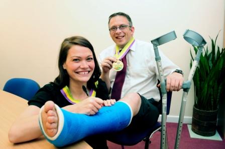 Mike Tomlinson with his leg in plaster after completing the Eden Half Marathon with a ruptured Achilles tendon. Signing the cast is Lightwater's office manager, Jodie Stredder