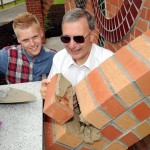Kyle Ainsley and Dave Linnell lay the final brick