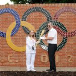 Olympic Torch Bearer Amy James and Dave Linnell with the Olympic Wall