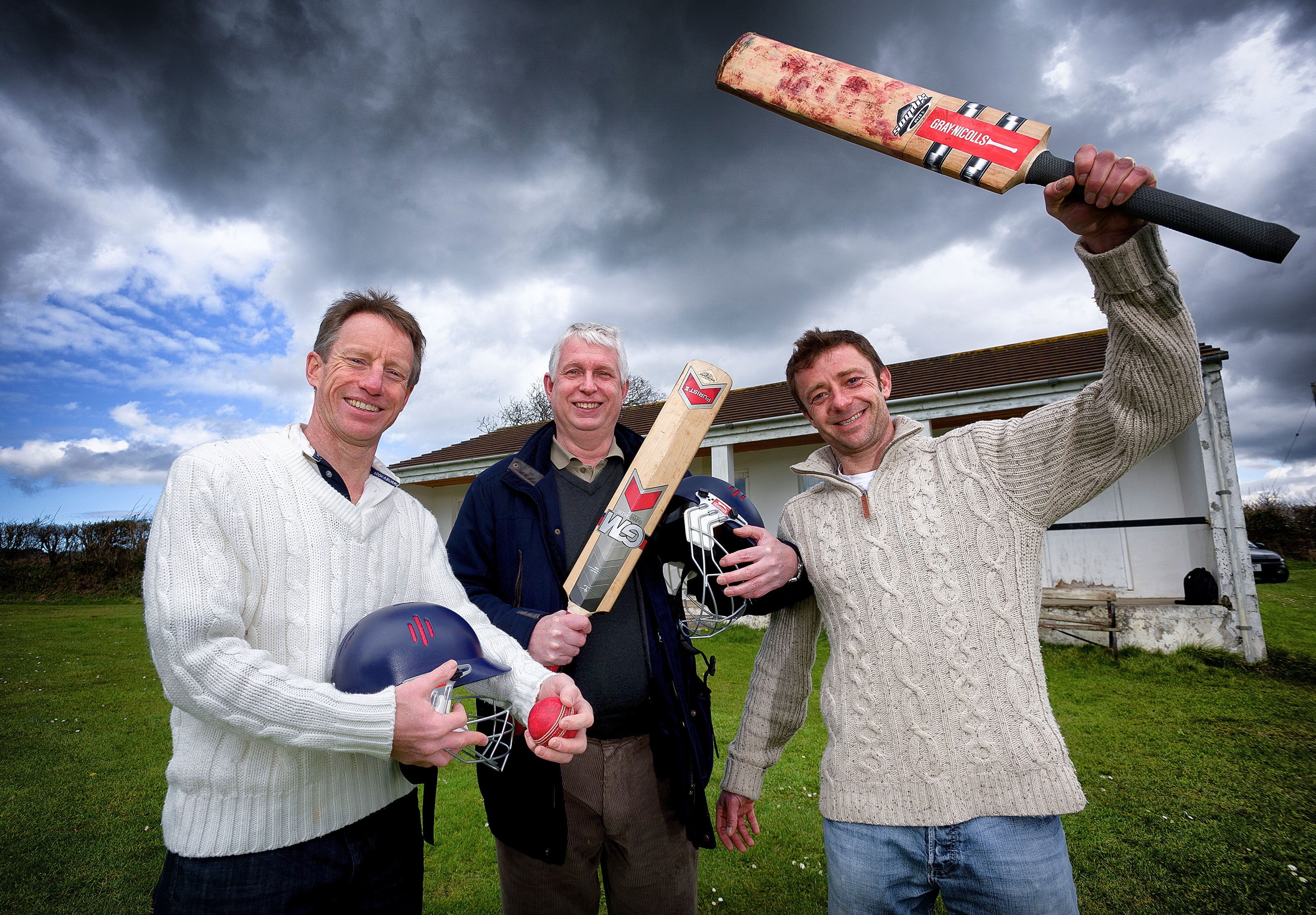 Howzat! Ladock Cricket Club's Paddy Morgan (left) and Mike Ellery (right) are bowled over after receiving a £500 award from Low Carbon Ladock's secretary, Joe Manders (centre)